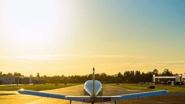 Rear view of a small plane ready to take off at the airport at sunrise